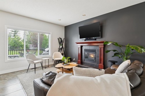 97 Tanner Close Se, Airdrie, AB - Indoor Photo Showing Living Room With Fireplace