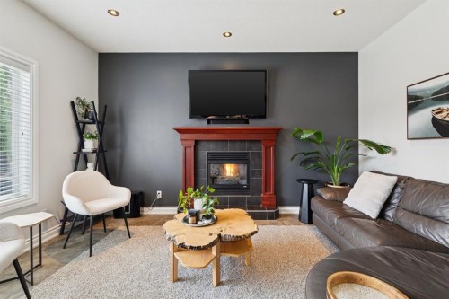 97 Tanner Close Se, Airdrie, AB - Indoor Photo Showing Living Room With Fireplace