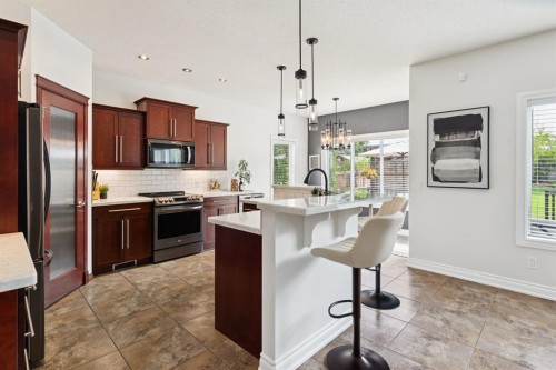 97 Tanner Close Se, Airdrie, AB - Indoor Photo Showing Kitchen With Upgraded Kitchen