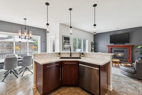 97 Tanner Close Se, Airdrie, AB - Indoor Photo Showing Kitchen With Fireplace