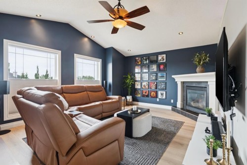 97 Tanner Close Se, Airdrie, AB - Indoor Photo Showing Living Room With Fireplace