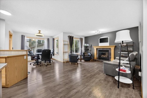2745 Coopers Manor Sw, Airdrie, AB - Indoor Photo Showing Living Room With Fireplace