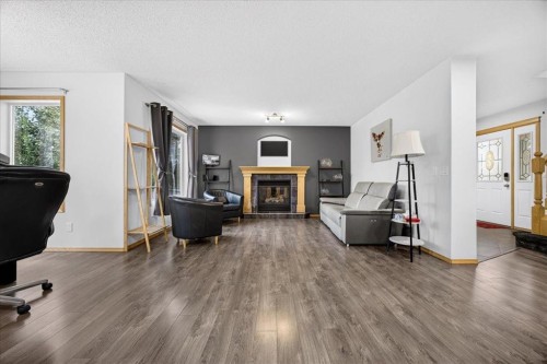 2745 Coopers Manor Sw, Airdrie, AB - Indoor Photo Showing Living Room With Fireplace