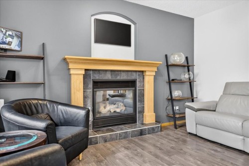 2745 Coopers Manor Sw, Airdrie, AB - Indoor Photo Showing Living Room With Fireplace