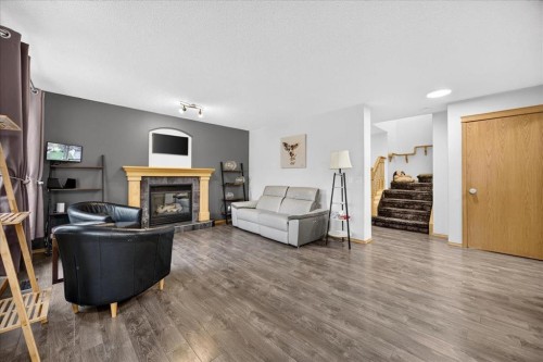 2745 Coopers Manor Sw, Airdrie, AB - Indoor Photo Showing Living Room With Fireplace