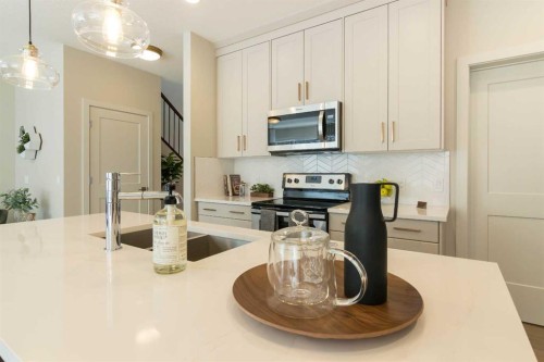 542 Rivercrest View, Cochrane, AB - Indoor Photo Showing Kitchen With Double Sink With Upgraded Kitchen