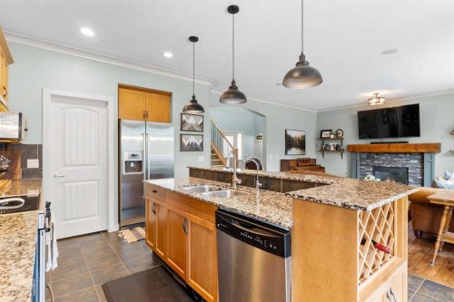 19 Sunset Circle, Cochrane, AB - Indoor Photo Showing Kitchen With Fireplace With Double Sink With Upgraded Kitchen