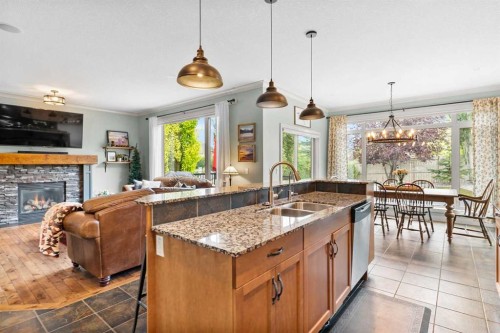 19 Sunset Circle, Cochrane, AB - Indoor Photo Showing Kitchen With Fireplace With Double Sink
