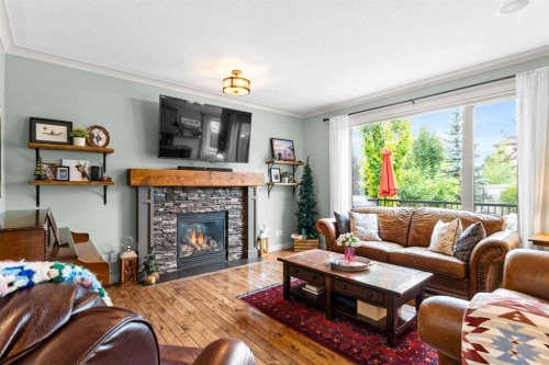 19 Sunset Circle, Cochrane, AB - Indoor Photo Showing Living Room With Fireplace