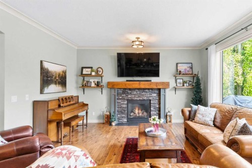 19 Sunset Circle, Cochrane, AB - Indoor Photo Showing Living Room With Fireplace