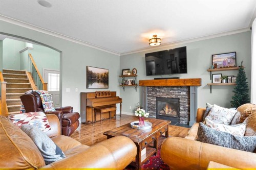 19 Sunset Circle, Cochrane, AB - Indoor Photo Showing Living Room With Fireplace