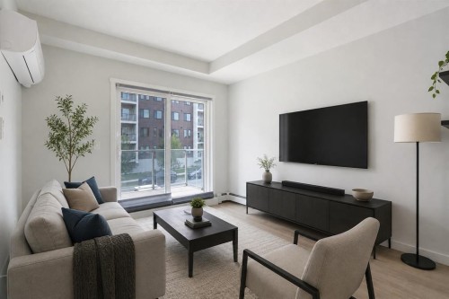 206-71 Shawnee Common Sw, Calgary, AB - Indoor Photo Showing Living Room