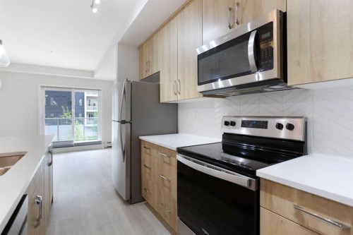 206-71 Shawnee Common Sw, Calgary, AB - Indoor Photo Showing Kitchen With Double Sink