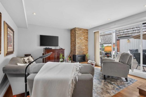 6-1726 8 Avenue Nw, Calgary, AB - Indoor Photo Showing Living Room With Fireplace