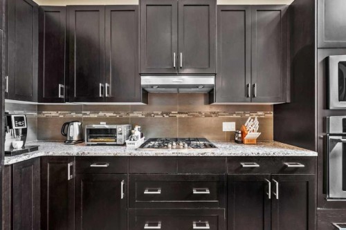 63 Cortina Villas Sw, Calgary, AB - Indoor Photo Showing Kitchen With Upgraded Kitchen