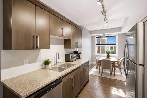 218 Cranford Se, Calgary, AB - Indoor Photo Showing Kitchen With Stainless Steel Kitchen With Double Sink With Upgraded Kitchen