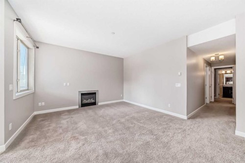 206-488 7 Avenue Ne, Calgary, AB - Indoor Photo Showing Other Room With Fireplace