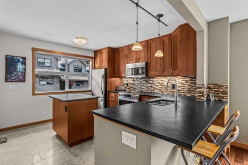 13-242 Benchlands Terrace, Canmore, AB - Indoor Photo Showing Kitchen With Double Sink