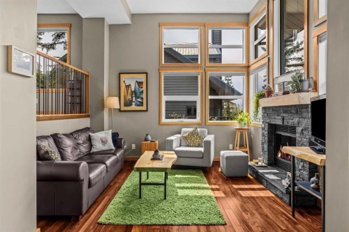 13-242 Benchlands Terrace, Canmore, AB - Indoor Photo Showing Living Room With Fireplace