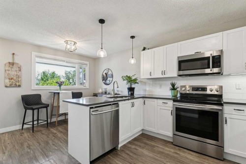 110S-203 Lynnview Road Se, Calgary, AB - Indoor Photo Showing Kitchen With Stainless Steel Kitchen With Upgraded Kitchen