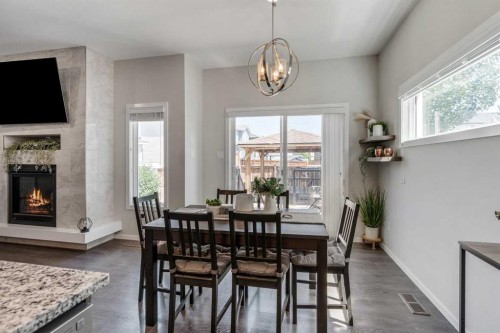 159 Pacific Landing West, Lethbridge, AB - Indoor Photo Showing Dining Room With Fireplace