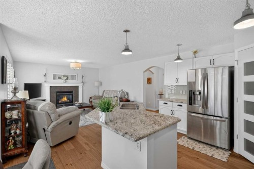 121 Rockyspring Terrace Nw, Calgary, AB - Indoor With Fireplace