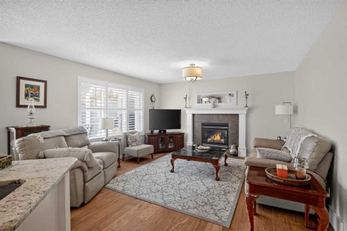 121 Rockyspring Terrace Nw, Calgary, AB - Indoor Photo Showing Living Room With Fireplace