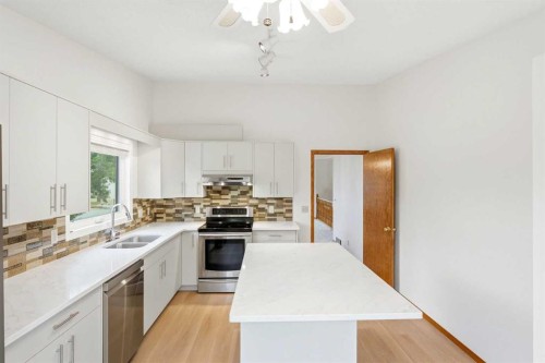 5 Sandpiper Gate Nw, Calgary, AB - Indoor Photo Showing Kitchen With Double Sink