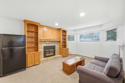 5 Sandpiper Gate Nw, Calgary, AB - Indoor Photo Showing Living Room With Fireplace