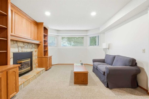 5 Sandpiper Gate Nw, Calgary, AB - Indoor Photo Showing Other Room With Fireplace