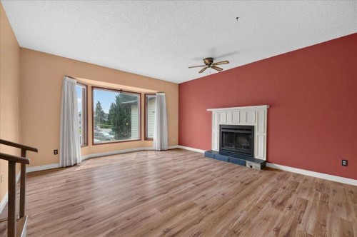 714 9 Avenue Se, High River, AB - Indoor Photo Showing Living Room With Fireplace
