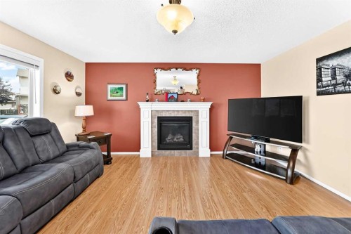 325 Luxstone Green Sw, Airdrie, AB - Indoor Photo Showing Living Room With Fireplace