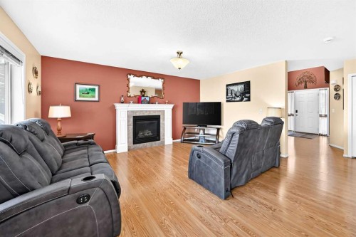 325 Luxstone Green Sw, Airdrie, AB - Indoor Photo Showing Living Room With Fireplace