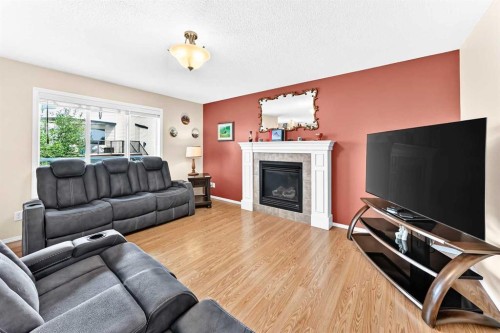 325 Luxstone Green Sw, Airdrie, AB - Indoor Photo Showing Living Room With Fireplace