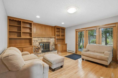 119 Strathbury Bay Sw, Calgary, AB - Indoor Photo Showing Living Room With Fireplace