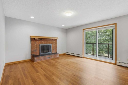 119 Strathbury Bay Sw, Calgary, AB - Indoor Photo Showing Living Room With Fireplace