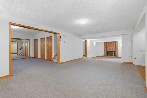 119 Strathbury Bay Sw, Calgary, AB - Indoor With Fireplace