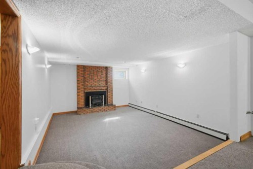 119 Strathbury Bay Sw, Calgary, AB - Indoor With Fireplace