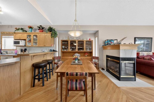 37 Scimitar Heath Nw, Calgary, AB - Indoor Photo Showing Dining Room With Fireplace