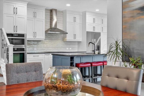 9 Drake Landing Square, Okotoks, AB - Indoor Photo Showing Kitchen With Upgraded Kitchen