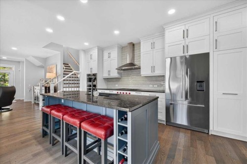 9 Drake Landing Square, Okotoks, AB - Indoor Photo Showing Kitchen With Stainless Steel Kitchen With Upgraded Kitchen
