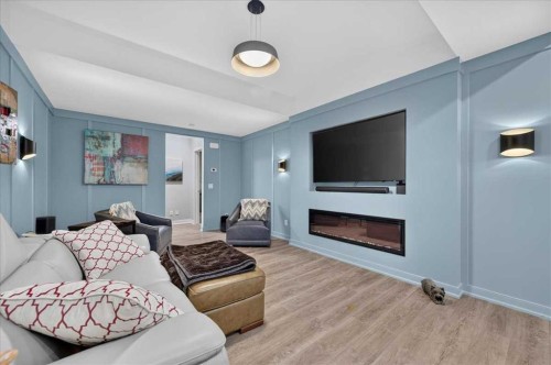 9 Drake Landing Square, Okotoks, AB - Indoor Photo Showing Living Room With Fireplace