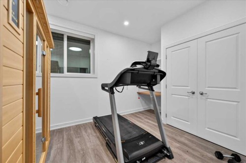 9 Drake Landing Square, Okotoks, AB - Indoor Photo Showing Gym Room