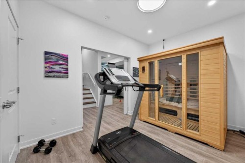 9 Drake Landing Square, Okotoks, AB - Indoor Photo Showing Gym Room