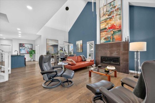 9 Drake Landing Square, Okotoks, AB - Indoor Photo Showing Living Room With Fireplace