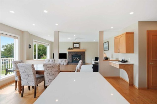 122 Douglas Woods Hill Se, Calgary, AB - Indoor Photo Showing Dining Room With Fireplace