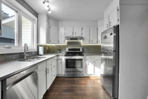 36 Coach Manor Rise Sw, Calgary, AB - Indoor Photo Showing Kitchen With Double Sink