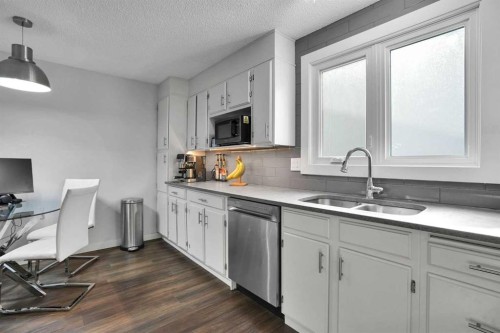 36 Coach Manor Rise Sw, Calgary, AB - Indoor Photo Showing Kitchen With Double Sink