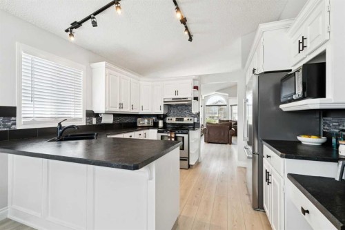 438 Sheep River Point, Okotoks, AB - Indoor Photo Showing Kitchen With Double Sink