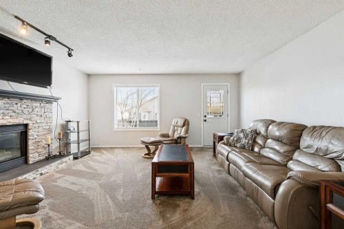 438 Sheep River Point, Okotoks, AB - Indoor Photo Showing Living Room With Fireplace